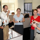 The departing Mooney (center) is surrounded by indifferent coworkers.
